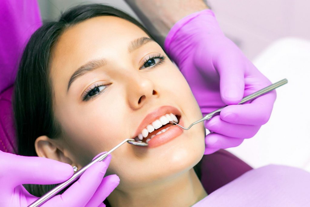dentist-examines-patients-teeth-dentist